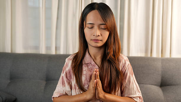 Person practising calm breathing in a cosy home setting